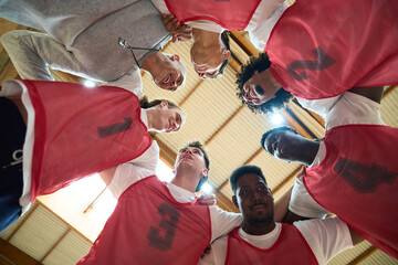 Basketball team and coach motivating before game start
