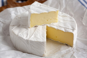 Homemade White Brie Cheese on a Wooden Board, side view. Close-up.