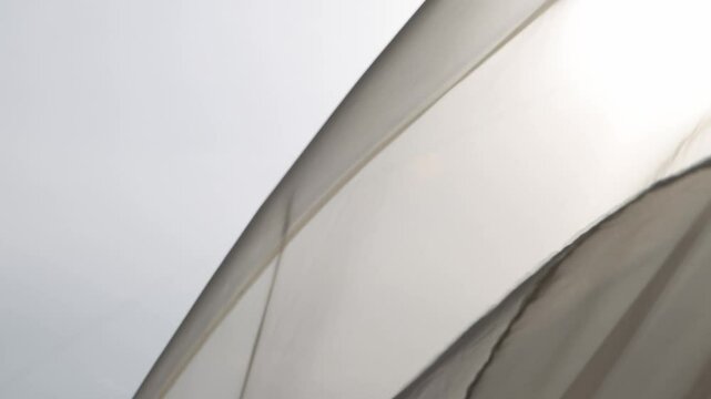 Light breezy sheer curtain blowing in the wind with sunset behind it