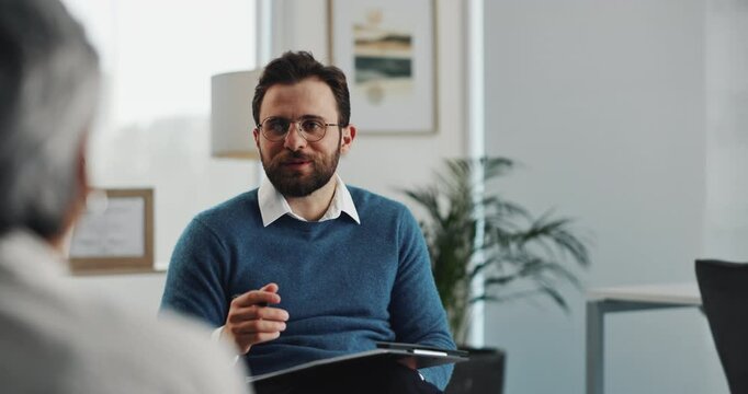 Man, therapist and talking with senior client for counseling therapy or health advice at office. Male person, counsellor or consultant speaking to patient for communication or helpful tips at session