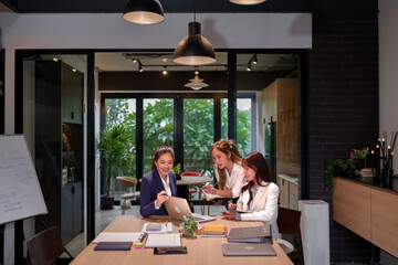 Asian Women in Modern Office Brainstorming Business Strategy Collaboration and Teamwork for Startup Success Professional Meeting Analyzing Data