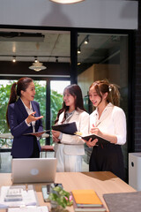Three Asian Business Women Collaboration in Modern Office Meeting Brainstorming Business Strategy Discussing Ideas and Planning for Success Professional Women Teamwork