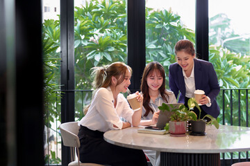 Asian Women Meeting Collaboration in Office Space with Laptop and Coffee Discussing Business Strategy Project for Startup Teamwork and Business Planning