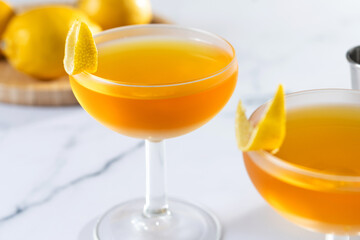 Paper plane cocktail on white marble and black background