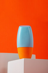 Blank tube with cosmetic product for moisturizing on orange background