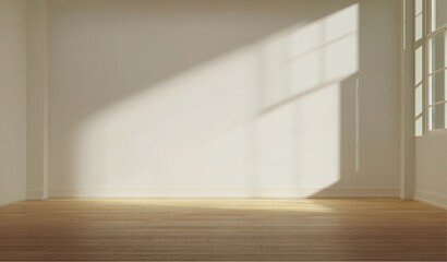 Light streams through window creating pattern on interior wall and hardwood floor in room at daytime
