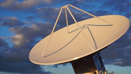 Large satellite dish pointing towards the sky at sunset, searching for extraterrestrial...