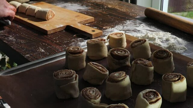 Cutting Cinnamon Roll Log into Individual Swirls for Homemade Cinnabon Pastries, Rustic Baking Process Concept