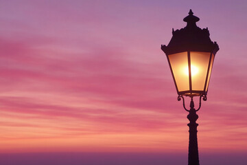 Close-up view of a streetlight illuminating the evening sky amidst a backdrop of swirling clouds