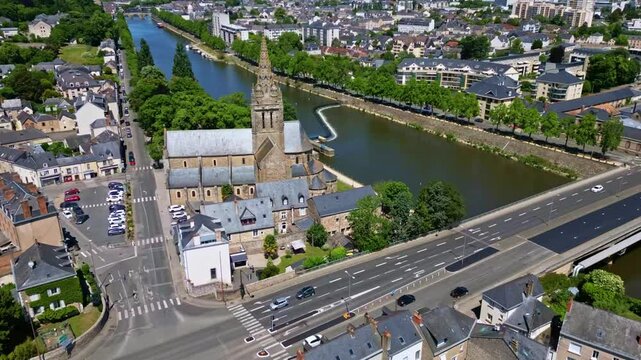 Hyperlapse drone circling Notre-Dame d&rsquo;Avesni&egrave;res with views of Mayenne River and surrounding houses in Laval, France