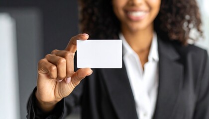 Office worker holding a horizontal business card, black background, strict business style, focus on hands and card.