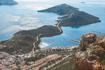 Aerial view of scenic coastal peninsula with marina and turquoise waters. Sustainable travel, slow tourism, eco escape, summer adventure, sea, freedom, mindful journey, digital detox.