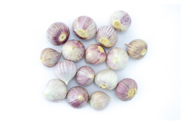 Group of single clove garlics (solo garlic, single bulb garlic) isolated on white background top view flat lay stack