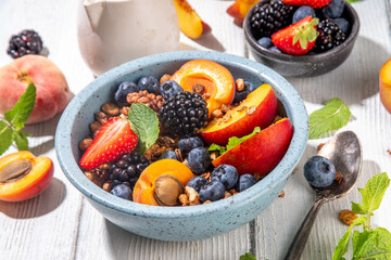 Granola breakfast with fruit and berry