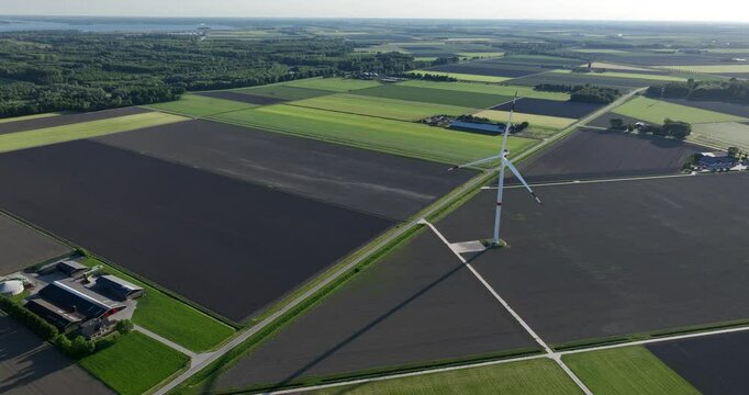 wind turbines in the Flevopolder, symmetrical agricultural fields, power from the wind, wind farms, electricity for households, wind energy, renewable electricity, sustainable energy. Aerial view.