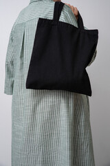 woman holding black reusable Shopper. Eco-friendliness in everyday life