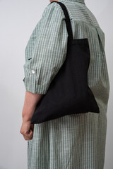 woman holding black reusable Shopper. Eco-friendliness in everyday life