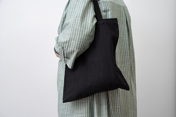 woman holding black reusable Shopper. Eco-friendliness in everyday life