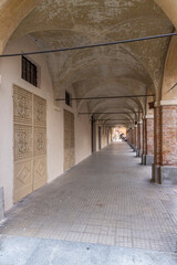 Fototapeta premium Arcades and decorated doors characterizing Via Baldassarre della Mantica in Cherasco, Italy