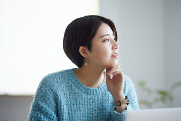 ノートパソコンで勉強をする若い日本人女性