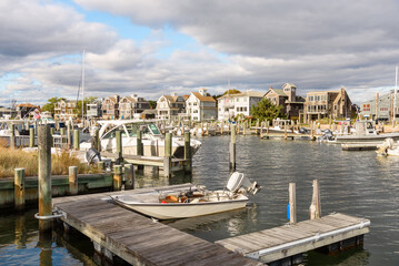 Botas in a harbour surrounded by traditional America wooden houses and aprtment buildings on a sunny autumn day