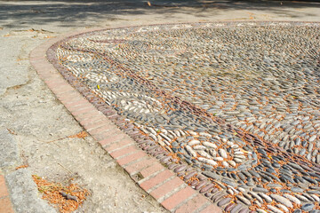 Mosaic lined with sea stones of different colors. Unusual mosaics, art