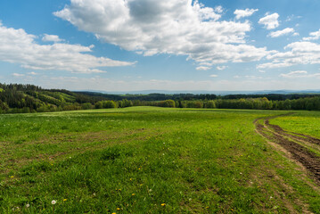 Springtime rolling landscape near Vysoky kamen hill in Krusne hory mountains