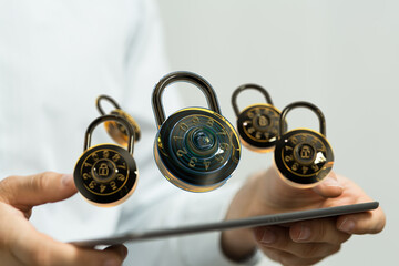 Image of combination locks hovering over a tablet, symbolizing digital security and data protection.