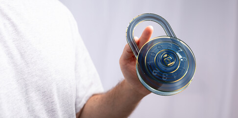 Image of a person holding a digital combination lock.  Perfect for cybersecurity, data protection,...