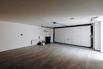 The garage is empty and features a sliding garage door for access