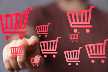 Person interacting with digital shopping carts.  E-commerce, online retail, digital marketing.