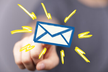 Bright, colorful image of a hand pointing at an email icon, symbolizing new messages or email...