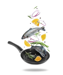Fototapeta na wymiar Sea trout with rosemary branches and lemon slices falling into frying pan on white background