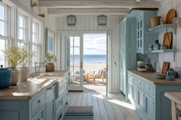 Beachfront kitchen with light blue cabinetry and ocean views.