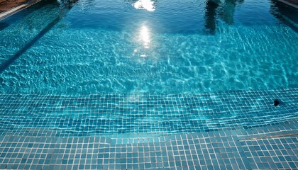Relaxing view of a shimmering swimming pool reflecting sunlight in a tranquil setting