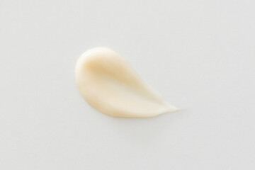 Beige cream smear on white background cosmetic skincare texture, minimalist close-up. Moisturizer, lotion, serum, shampoo, hair conditioner or foundation