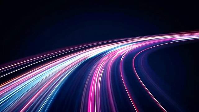 Blurred motion of bright white, pink, and blue lights curving across a dark background gives the illusion of high speed streaks - Powered by Adobe