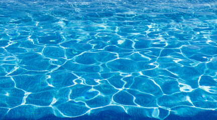 Water in swimming pool, ripple water surface and sun reflection