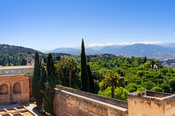 View of the Sierra Nevada from a tower of the Alhambra in Granada, in springtime with blue sky.