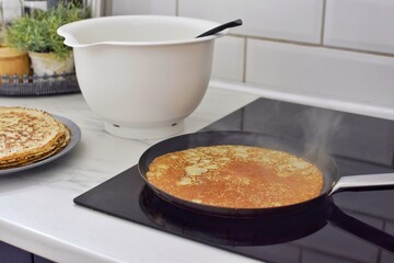 Making thin pancakes, home cooking.