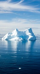 Majestic antarctic iceberg in calm ocean waters under a blue sky