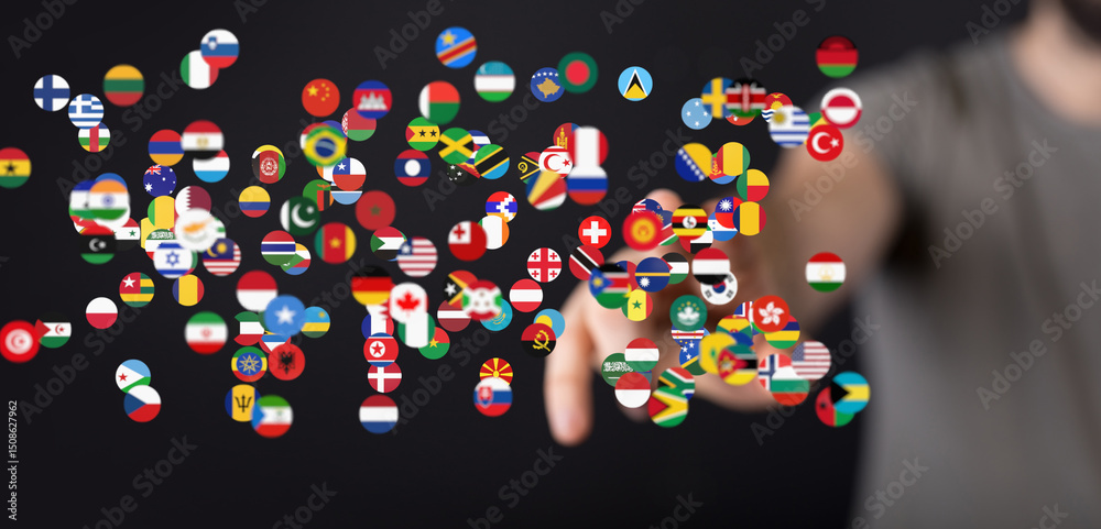 Fototapete hand interacting with a digital display of world flags, symbolizing global connection and communicat