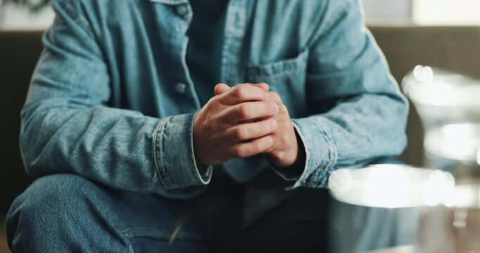 Nervous, hands and man with anxiety in home with stress, mental health or overthinking on sofa. Worry, panic attack and male person stimming for fear, phobia or trauma in crisis with trigger in house