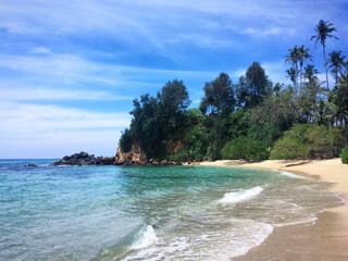 Sandy beach with turquoise waters and palm trees near Ahangama, Southern Province, Sri Lanka, March...