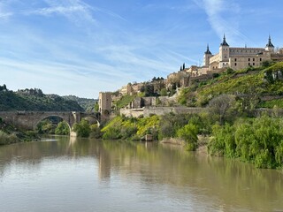 Historic Puente de Alcantara bridge over the river Tagus and the medieval town Toledo, Castile-La Mancha, Spain, April 2024