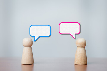 Wooden Figurines Facing Each Other with Speech Bubbles Showing Conversation and Dialogue