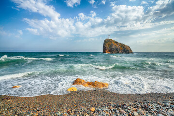 Amazing view of sea waves crashing on the shore and flowing above seashore pebbles.