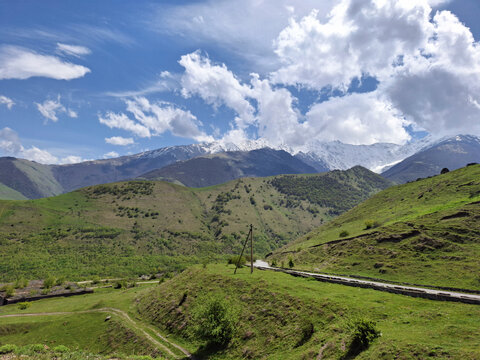 Scenic mountain landscape with lush greenery and blue sky   - Powered by Adobe