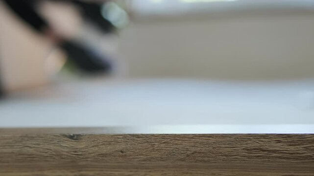 Realistic close-up footage of mattress cleaning at home. A woman uses a brush and spray to remove stains from the fabric. Face is blurred. Perfect for home hygiene concepts, advertising, and text