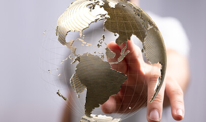 Abstract image of a hand interacting with a digital globe, representing global connectivity and...